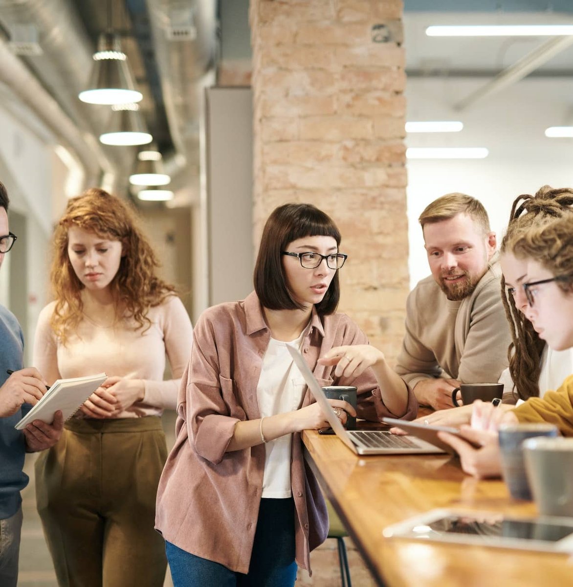 A group of technology professionals collaborating around a table
